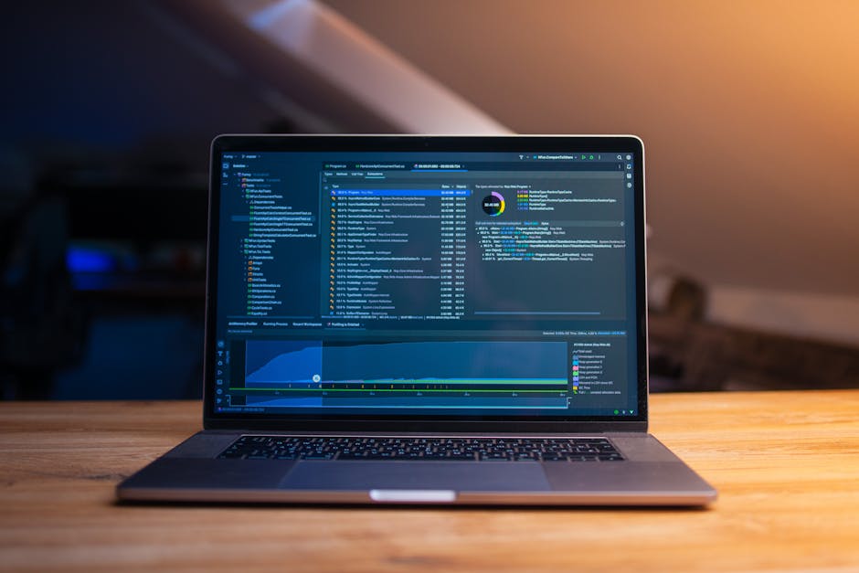 Laptop on a desk showing a software dashboard