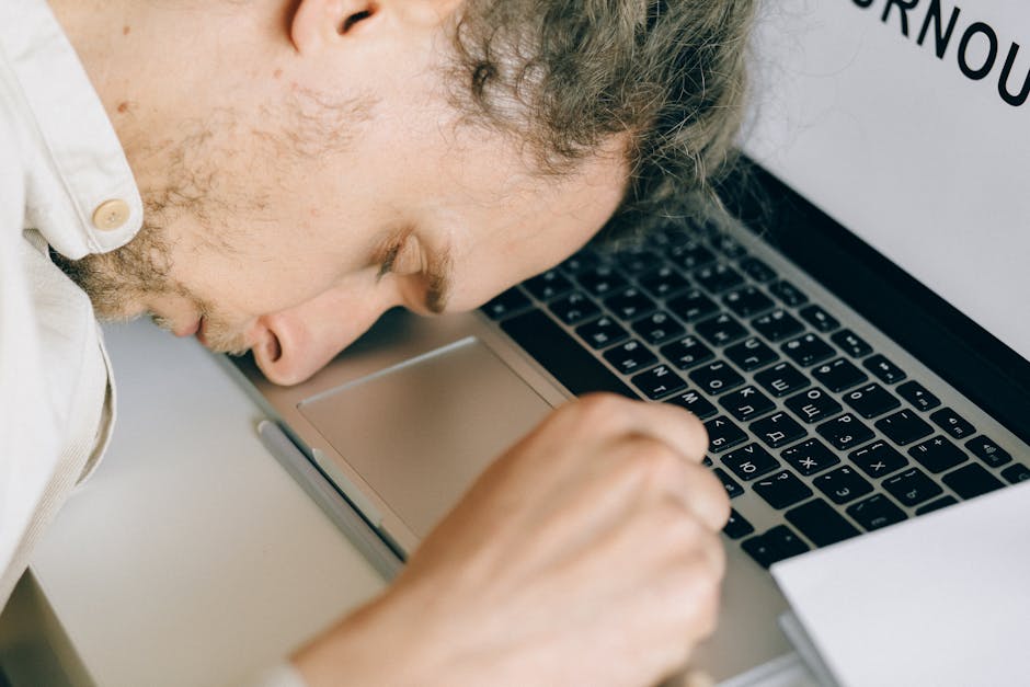 Person working late at a laptop in a dim office